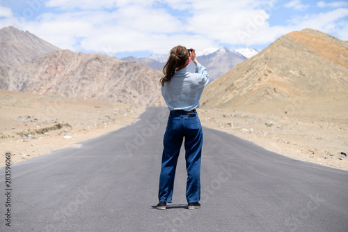 Portrait of young Asian woman talking photos on road in Ladakh. outdoors and traveller concept photo