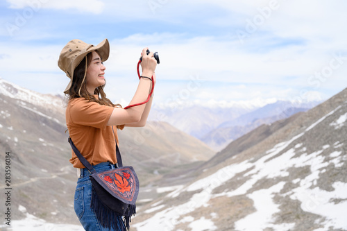 Photography Portrait of young Asian woman talking photos on snow mountain, outdoors and trav