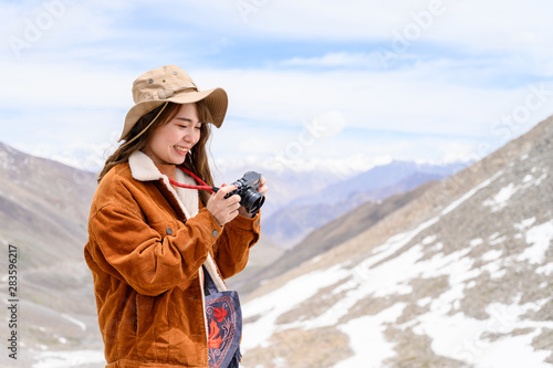 Photography Portrait of young Asian woman talking photos on snow mountain, outdoors and trav