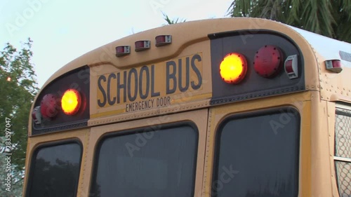 School bus rear door closeup flashing lights-early morning
