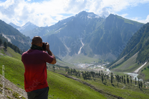 Photography A man taking photos of mountain in Kashmir