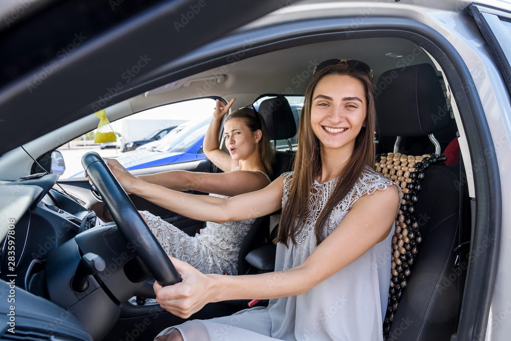 Two happy girls smiling and travelling in car Two happy girls smiling and travelling in car