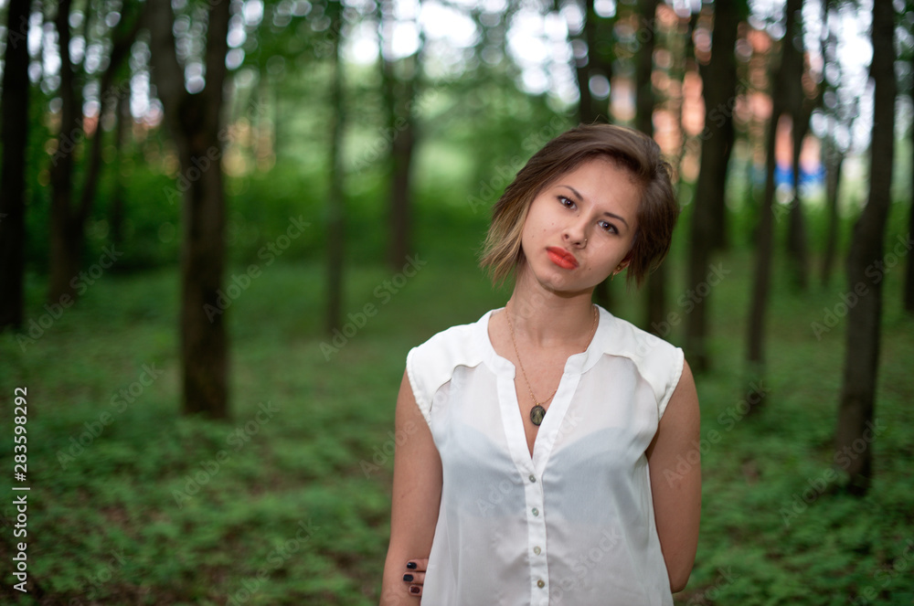 portrait of young woman in park portrait of young woman in park