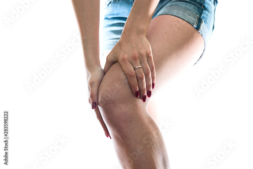 Female hands on the knee with ache