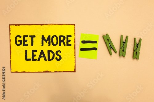 Word writing text Get More Leads. Business concept for Inbound Marketing Process of attracting prospective buyer Yellow piece paper reminder equal sign several clothespins sending message