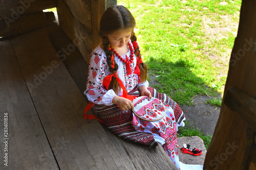 Girl Embroidery Rushnik.Hands of girl woman female in ukrainian traditional shirt sewing embroidery pattern in embroidery frame.