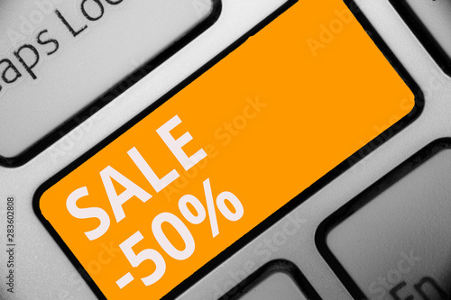 Writing note showing Sale 50. Business photo showcasing A promo price of an item at 50 percent markdown Keyboard orange key Intention computer computing reflection document photo