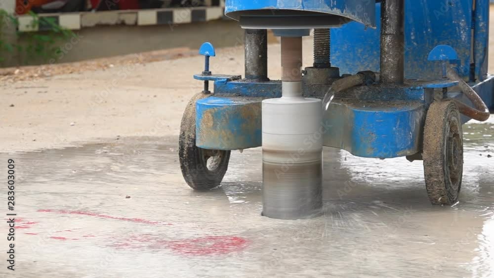 Closeup of a machine core drilling a hole in concrete on a construction site Closeup of a machine core drilling a hole in concrete on a construction site