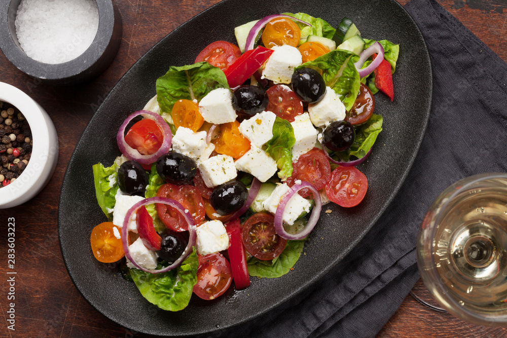 Greek salad plate and white wine