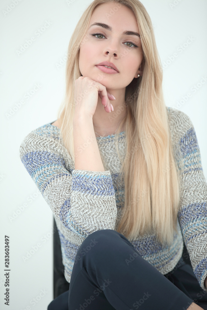 close up. stylish young business woman sitting on a chair close up. stylish young business woman sitting on a chair