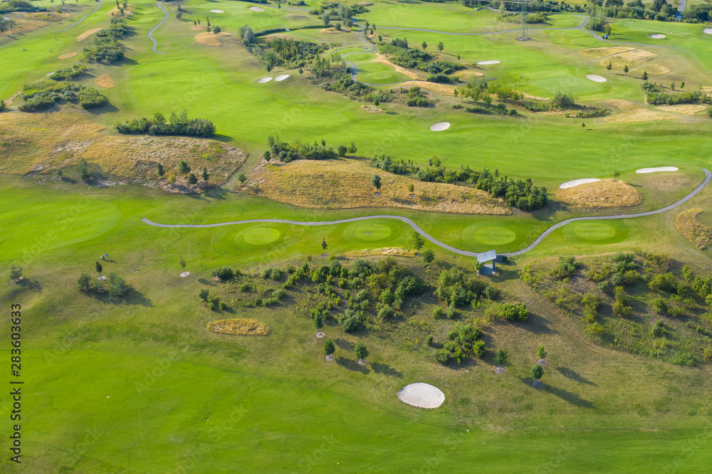 Aerial view of golf course. Drone or helicopter view of green field sand bunker