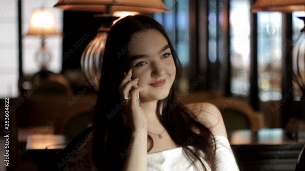 Beautiful girl talking on the phone, smiling, nodding her head. Beautiful girl talking on the phone, smiling, nodding her head.