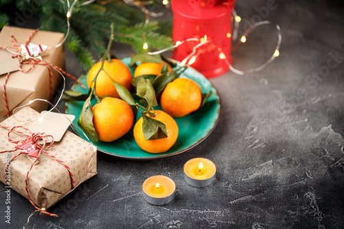 Top view of a table with tangerines  candles  and gift boxes