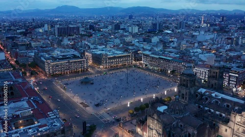 evening flying counter clockwise over cathedral around Mexico City Zocalo photo