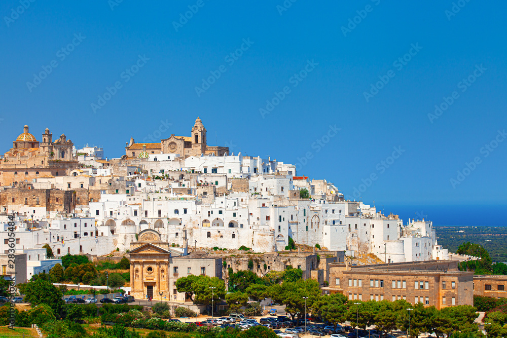 Ostuni white town skyline and Madonna della Grata church with clean blue sky, Brindisi, Apulia southern Italy. Europe