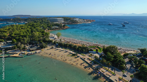 Fototapeta Naklejka Na Ścianę i Meble -  Aerial drone photo of famous paradise celebrity sandy beach of Astir or Asteras in south Athens riviera with turquoise clear waters, Vouliagmeni, Greece