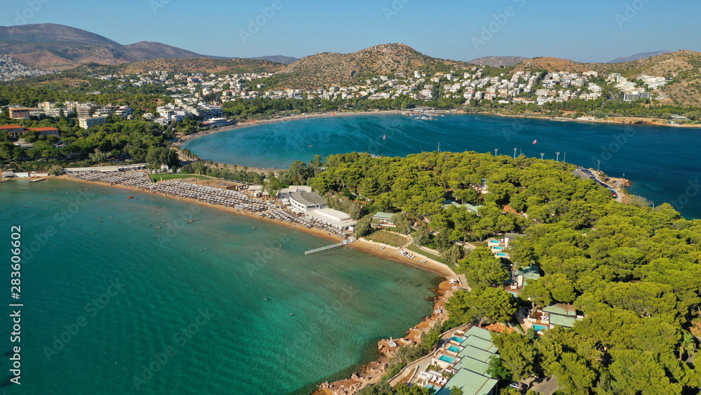 Aerial drone photo of famous paradise celebrity sandy beach of Astir or Asteras in south Athens riviera with turquoise clear waters, Vouliagmeni, Greece