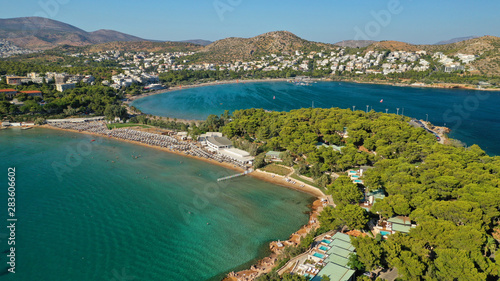 Aerial drone photo of famous paradise celebrity sandy beach of Astir or Asteras in south Athens riviera with turquoise clear waters, Vouliagmeni, Greece