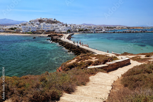 Naxos town and causeway across turquoise Aegean Sea from the Islet of Palatia, Naxos, Greek Islands © Steve McHale