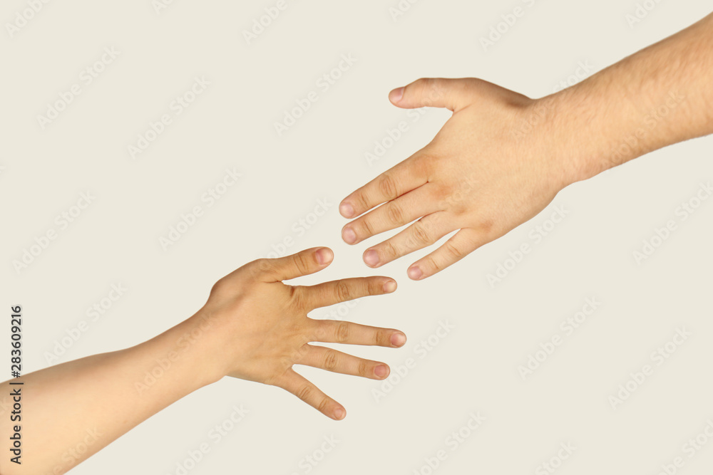 two hands, male and female, with the back of the palms on a light background, close-up, copy space, isolate