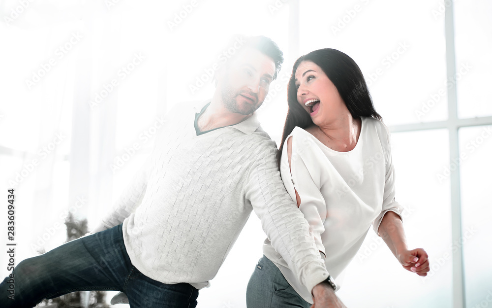 Fototapeta premium happy couple dancing in new house