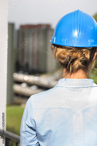 Architect woman from the back giving approval to the completion of the work.