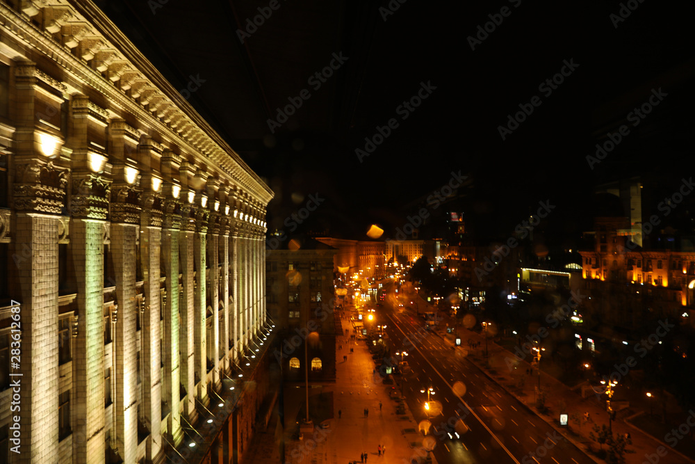 KYIV, UKRAINE - MAY 22, 2019: Beautiful view of illuminated Khreshchatyk street with road traffic and City Council building KYIV, UKRAINE - MAY 22, 2019: Beautiful view of illuminated Khreshchatyk street with road traffic and City Council building