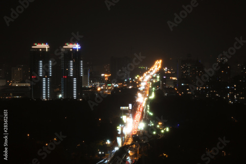 KYIV, UKRAINE - MAY 22, 2019: View of night city with apartment complex Soniachna Riviera and Metropolitan Andrey Sheptytsky Street photo