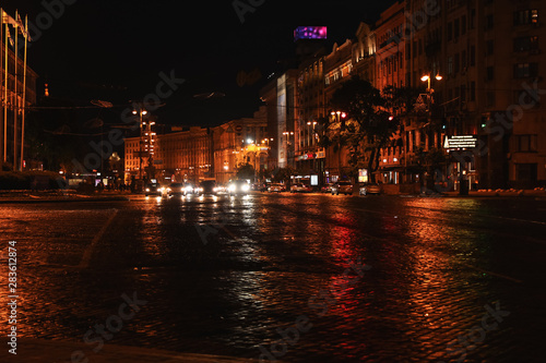 KYIV, UKRAINE - MAY 21, 2019: Night cityscape with illuminated buildings and street traffic