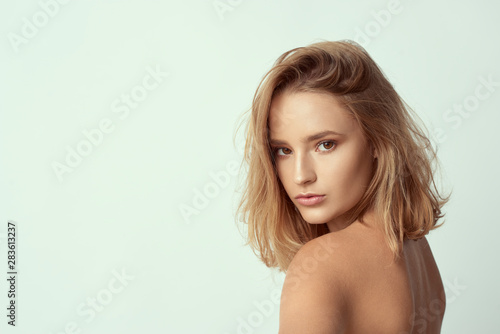 young cute and adorable girl on empty background, blond hair, empty for description, close up studio shot