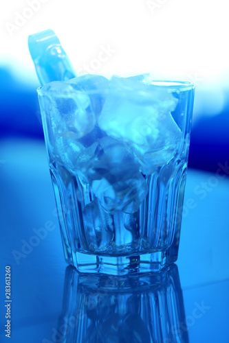 Macro photo of blue coarse ice in a transparent glass