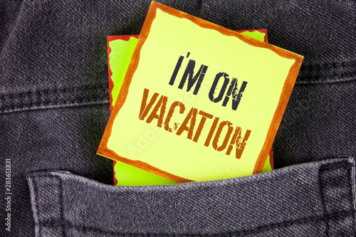 Handwriting text writing I Am im On Vacation. Concept meaning Break from stressful work pressure travel worldwide written Sticky Note Paper placed the Jeans background.