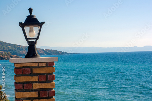old street lamp on a background of blue sky