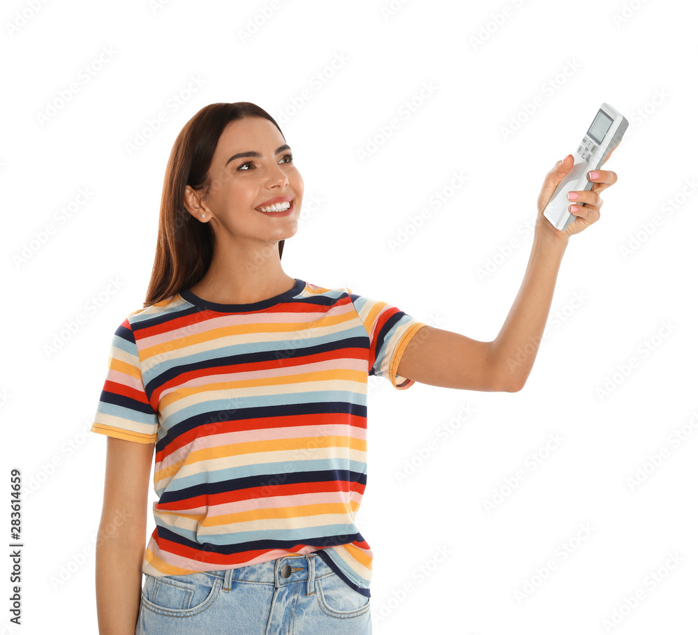 Young woman turning on air conditioner against white background Young woman turning on air conditioner against white background
