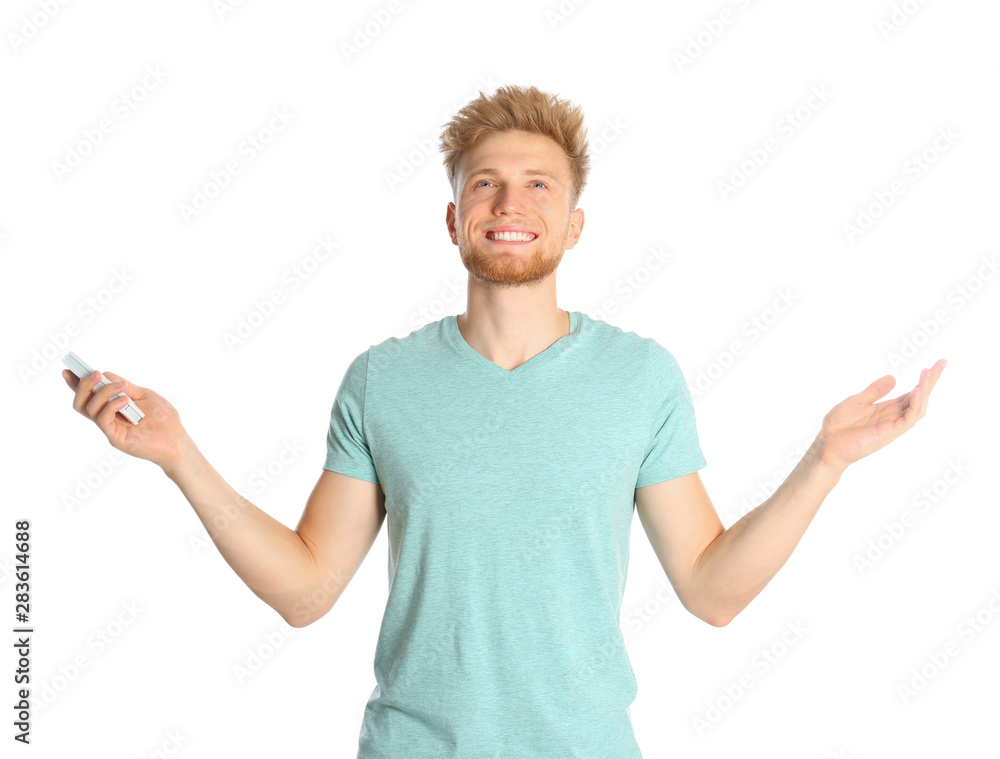 Young man with air conditioner remote on white background Young man with air conditioner remote on white background
