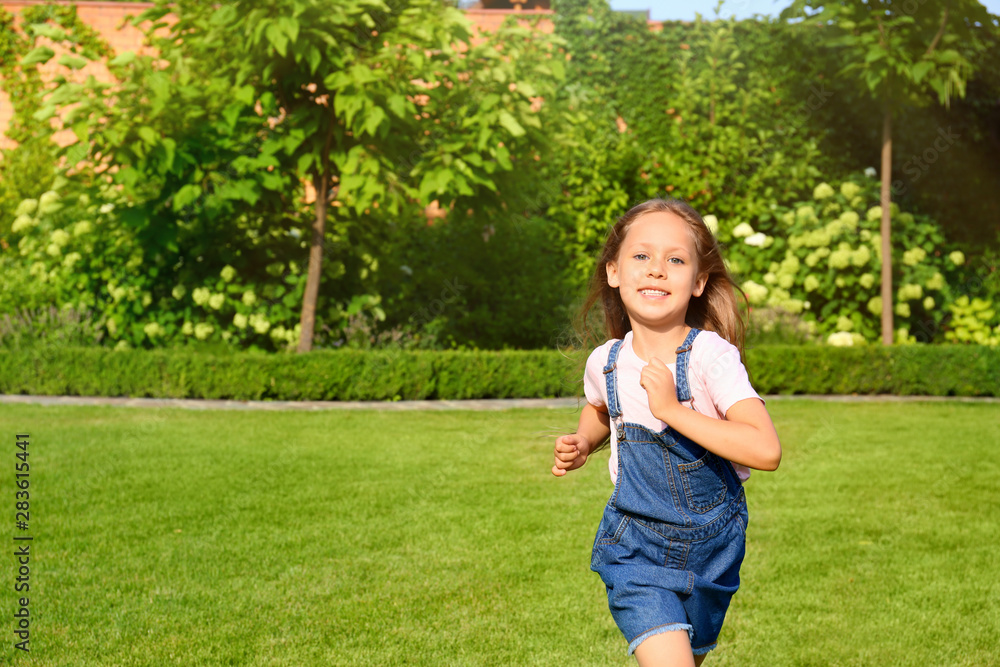 Cute little girl running in green park on summer day Cute little girl running in green park on summer day