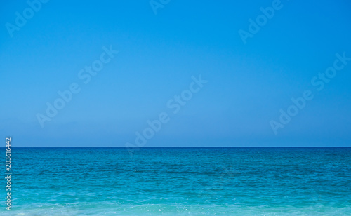Turquoise color sea and blue sky. Seascape background image.
