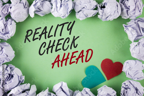 Text sign showing Reality Check Ahead. Conceptual photo Unveil truth knowing actuality avoid being sceptical written plain green background within White Paper Balls Hearts next to it. photo