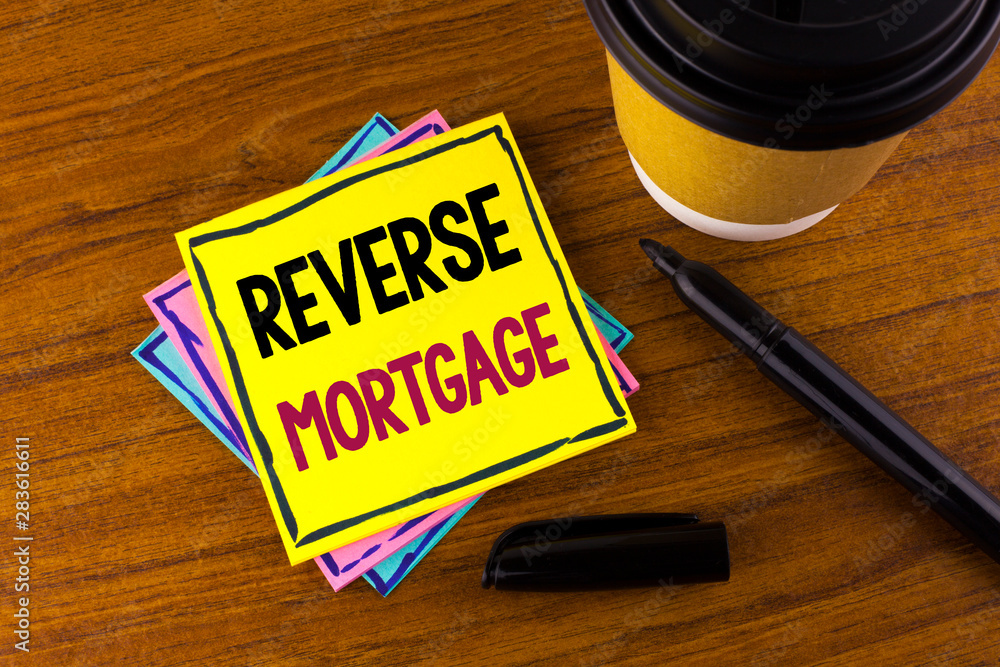 Word writing text Reverse Mortgage. Business concept for Elderly homeowner retirement option regular payment benefit written Sticky Note Paper wooden background Marker Cup next to it. Word writing text Reverse Mortgage. Business concept for Elderly homeowner retirement option regular payment benefit written Sticky Note Paper wooden background Marker Cup next to it.