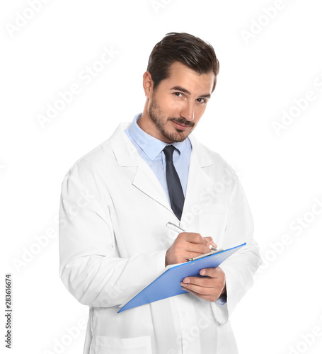 Young male doctor writing on clipboard against white background. Medical service