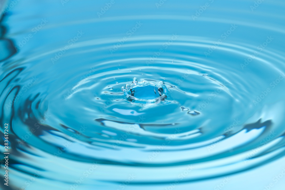 Splash of blue water with drop, closeup Splash of blue water with drop, closeup