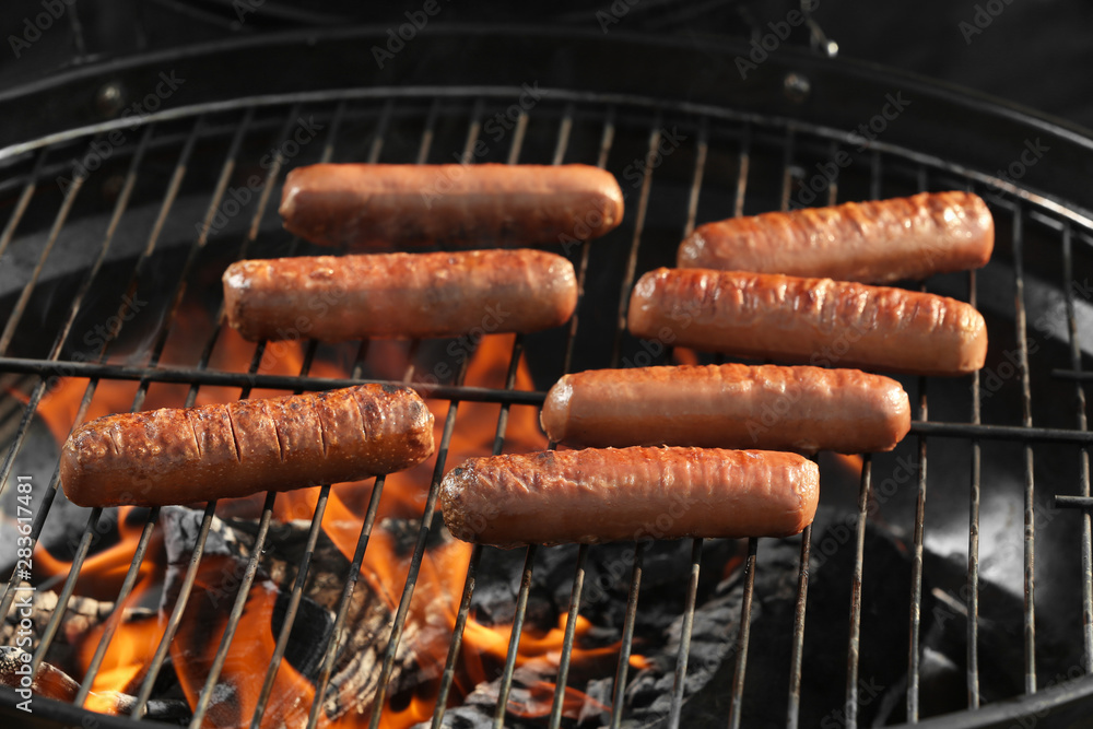 New modern barbecue grill with tasty sausages, closeup New modern barbecue grill with tasty sausages, closeup