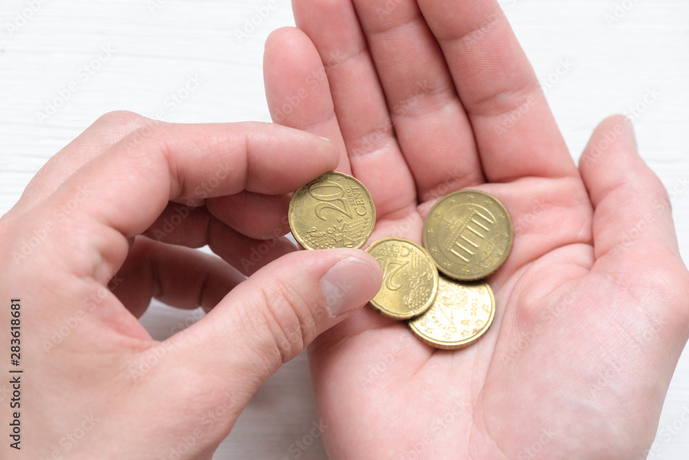 Man is counting his last money on a white wooden table background. Man is counting his last money on a white wooden table background.