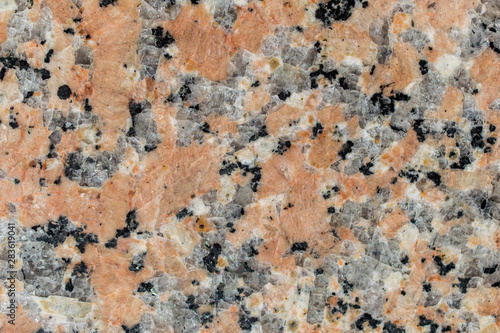 Texture of reddish color stone with quartz. Stone background.