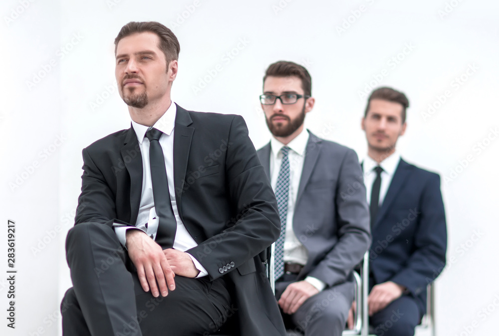 group of serious business people waiting for their turn group of serious business people waiting for their turn