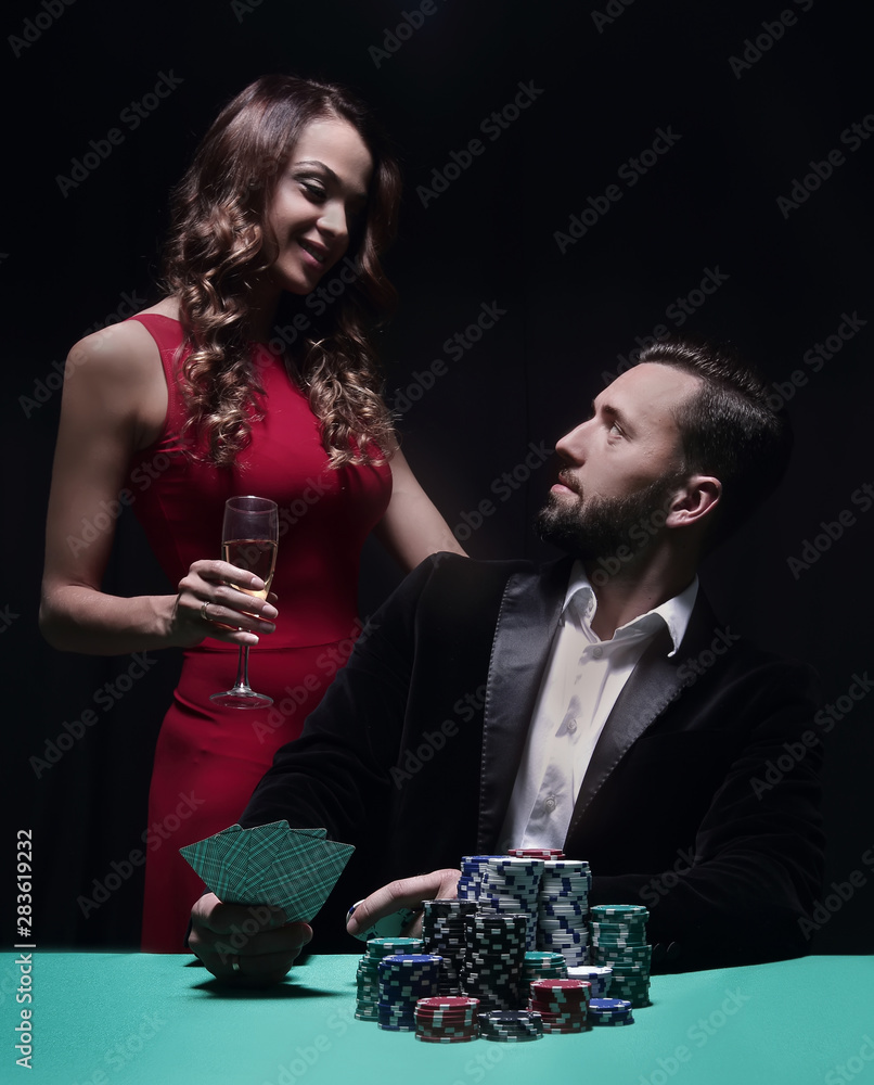 beautiful couple looking at playing cards at poker beautiful couple looking at playing cards at poker