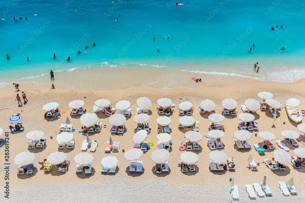 Peaople resting on the beach, umbrella rows, Kaputash, Turkey Peaople resting on the beach, umbrella rows, Kaputash, Turkey