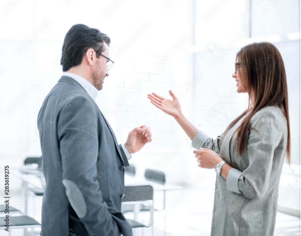 businessman and businesswoman discussing something in the new office businessman and businesswoman discussing something in the new office