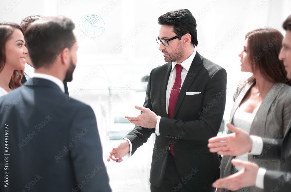 close up.a group of employees talking standing in a circle close up.a group of employees talking standing in a circle