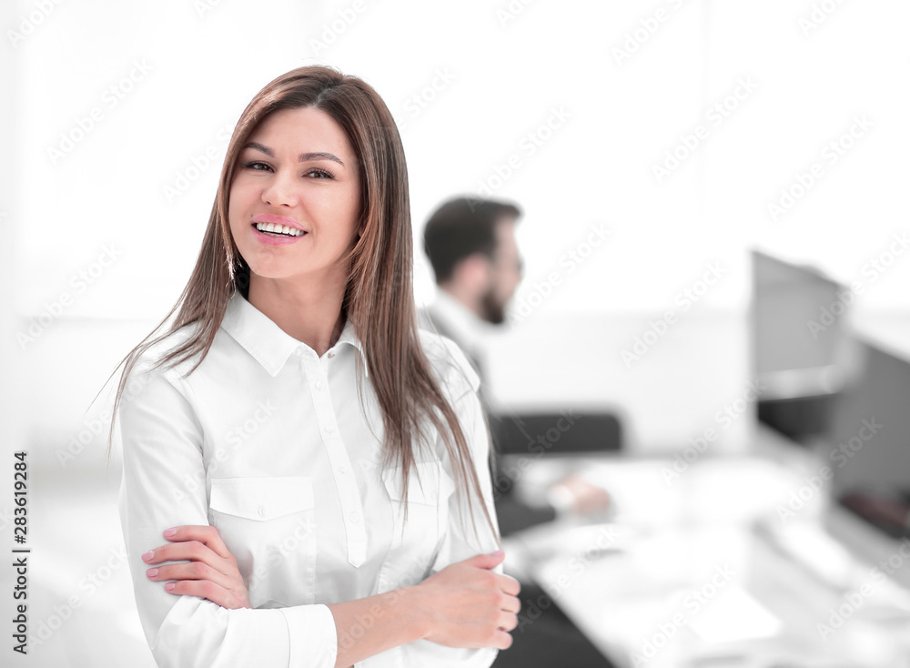 smiling business woman on the background of the workplace. smiling business woman on the background of the workplace.